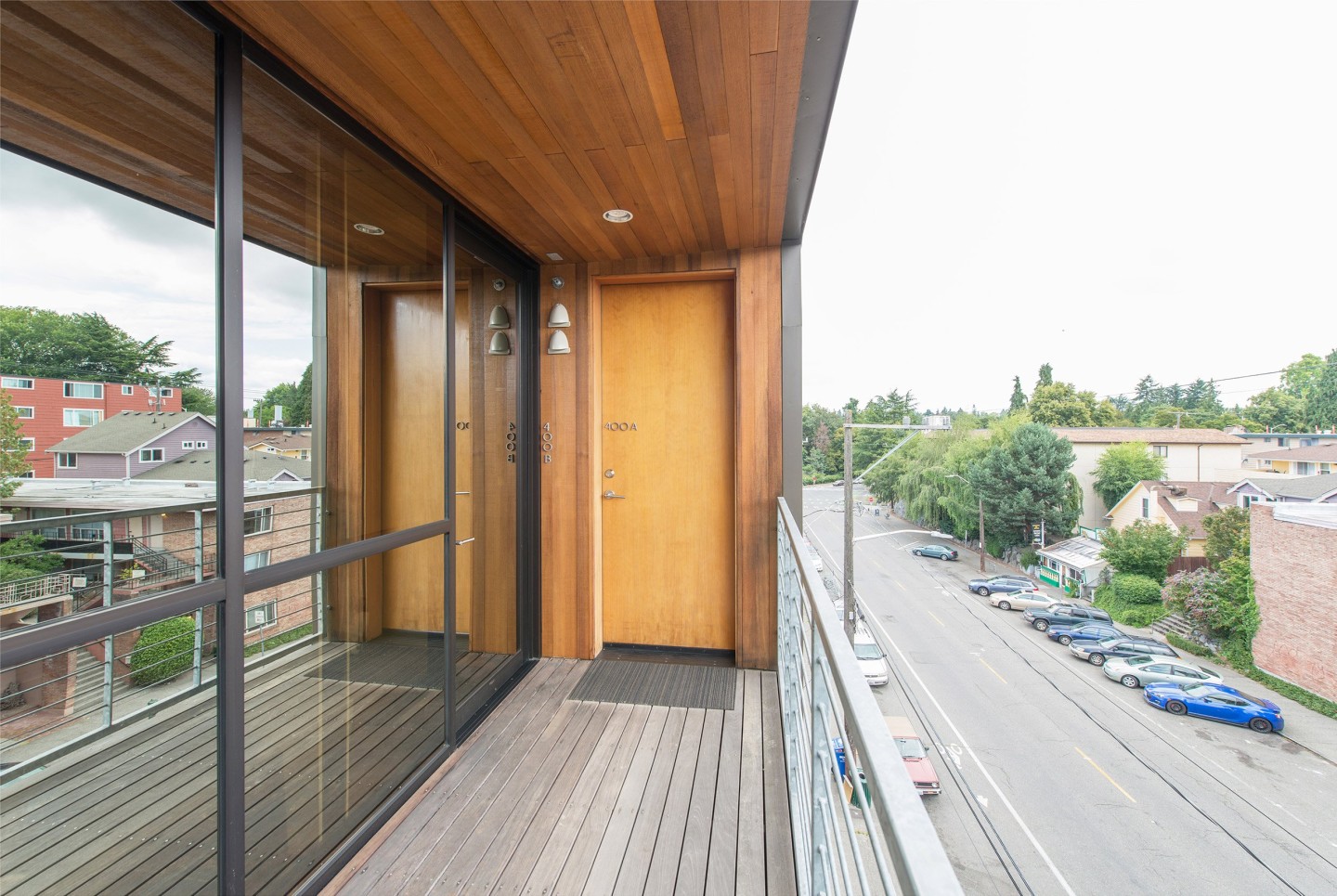 Park Modern, apartment entryway. Photograph courtesy of Chase Jarvis/BUILD LLC. Photo from the deck of a building facing the door. Windows reflect the street view outside of the city.